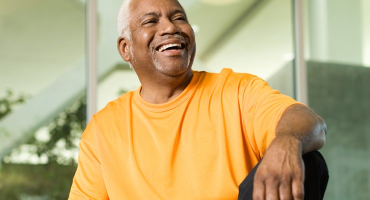 older man sitting on weight bench