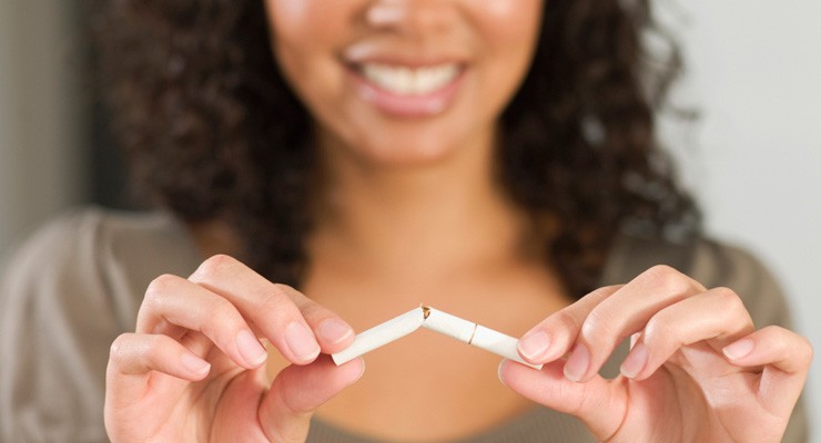 image of woman breaking a cigarette